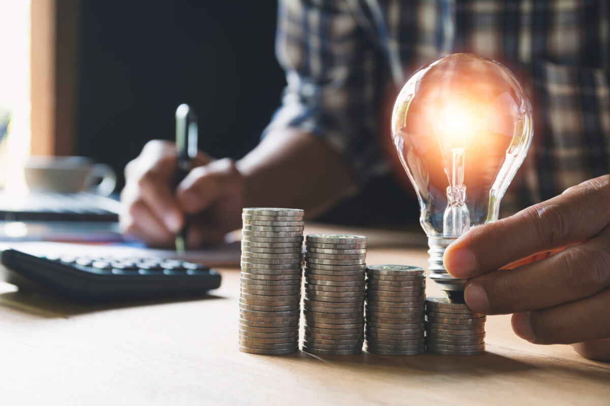 Hand Of Male Holding A Light Bulb And Copy Space For Accounting,